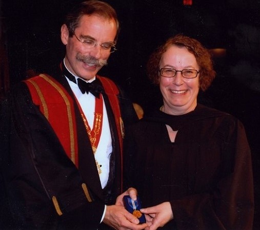 Dr. Simons receiving award